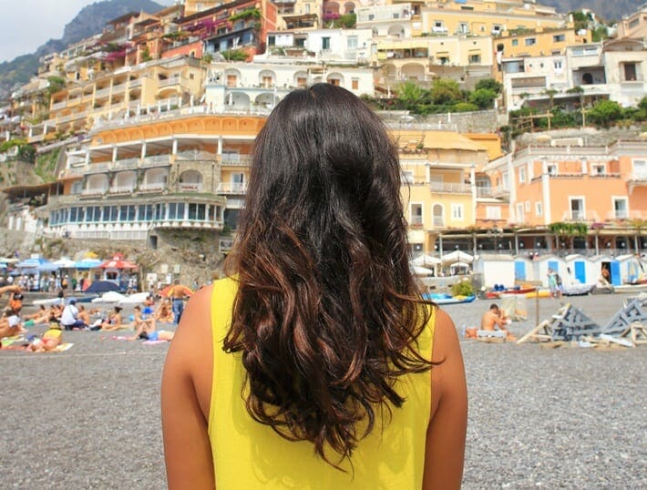 Back of a woman's head with Positano landscape in the background