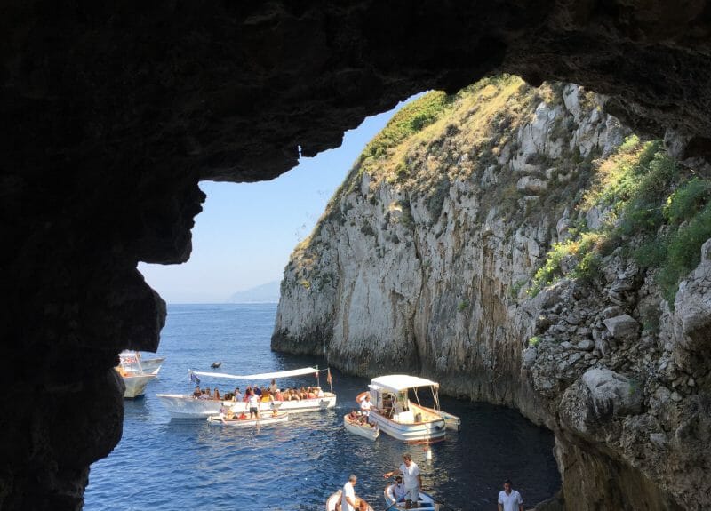Boats lining up to go into the Blue Grotto in Capri Italy
