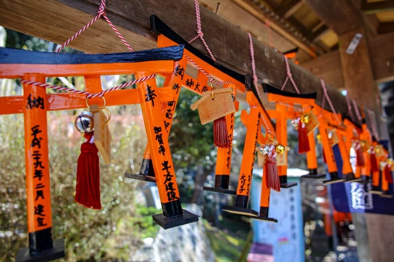 Mini tori gates hanging at Fushimi Inari in Kyoto Japan