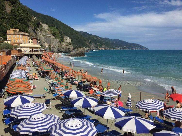 Umbrellas on the beach in Monterosso in Cinque Terre Italy