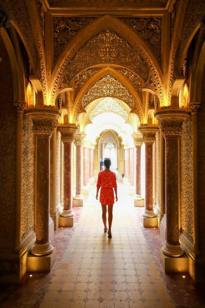 Woman walking down hallway in Monserrate Palace in Sintra Portugal