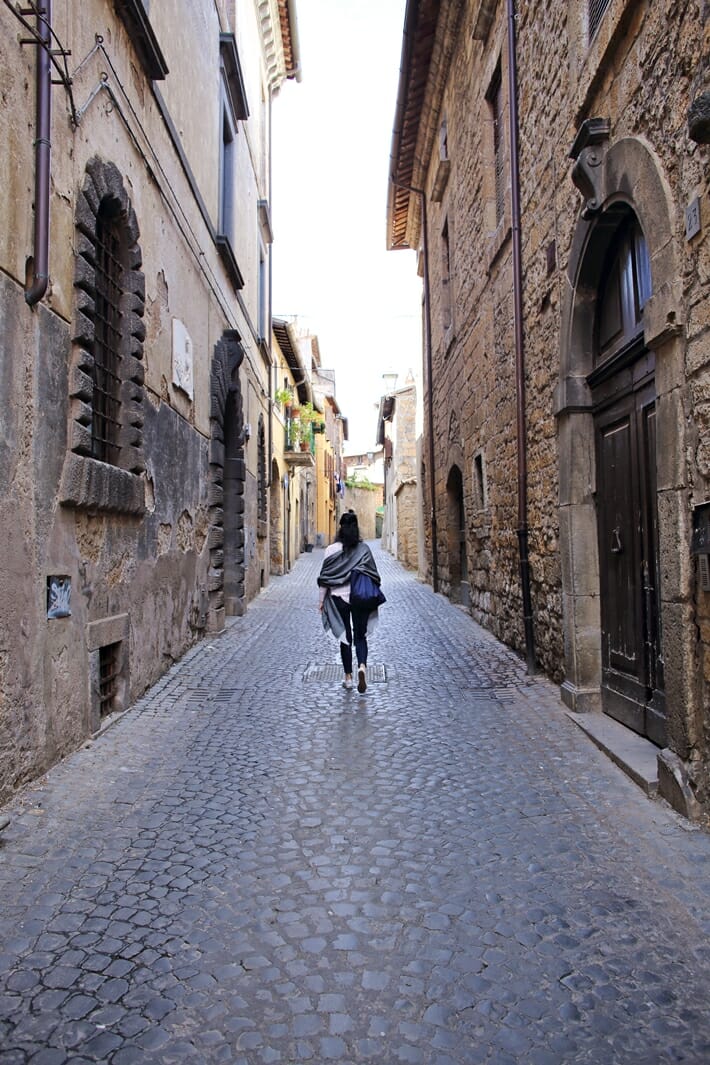 Woman walking down the street in Orvieto in Umbria, Italy