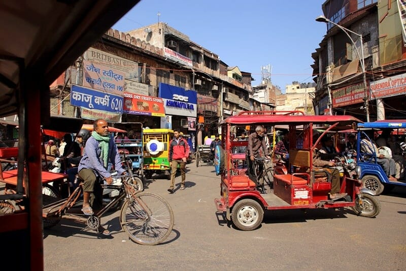 Tuk tuks driving through Chandi Chowk in Old Delhi India