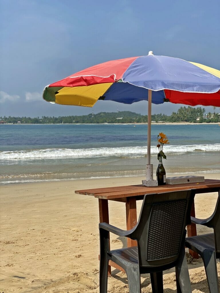 Beach umbrella and table on Pehebiya Beach in Sri Lanka