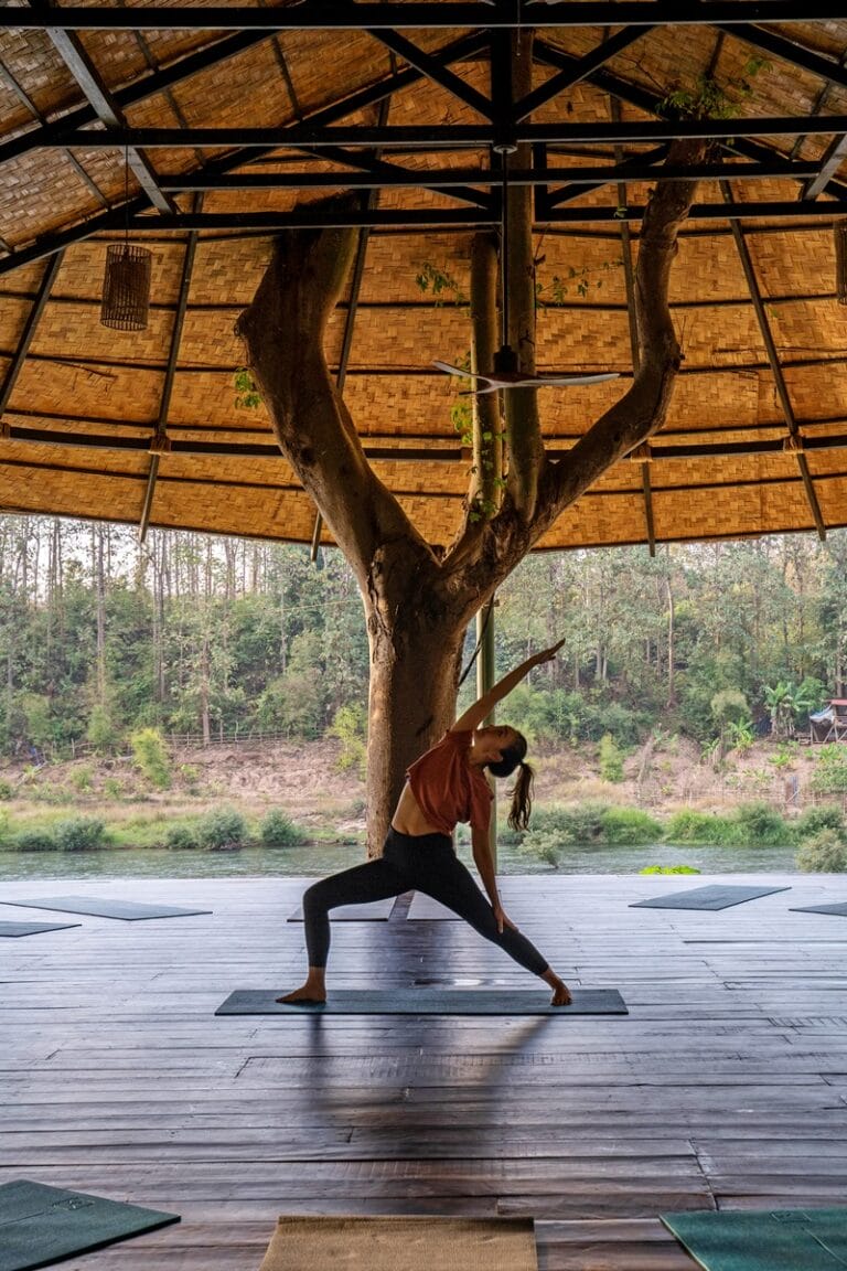 Woman practicing yoga asanas at the Yoga shala at The NamKhan in Luang Prabang Laos