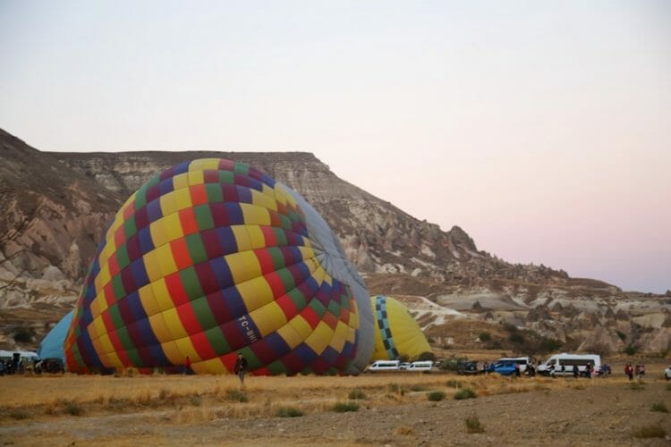 Hot air balloons filling up in the morning in Cappadocia