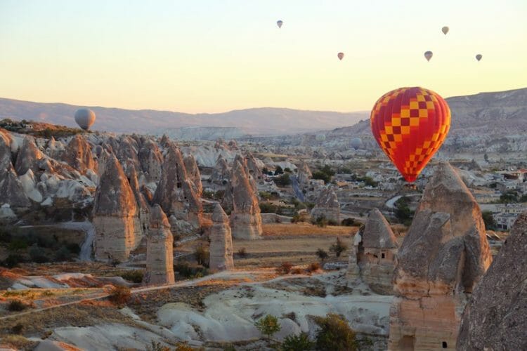 Hot air balloons over fairy chimneys in Cappadocia Turkey