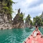 Woman sitting on a boat in Khao Sok National Park Cheow Lan Lake in Thailand