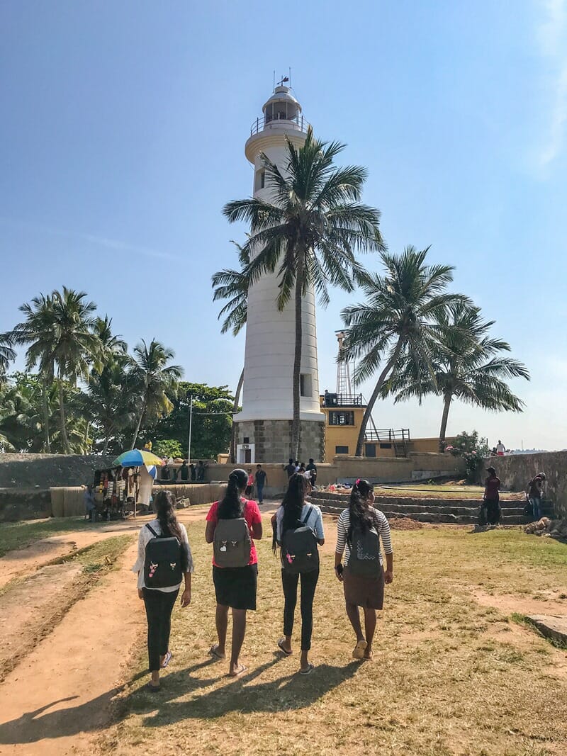 Women walking in front of Galle Lighthouse in Sri Lanka