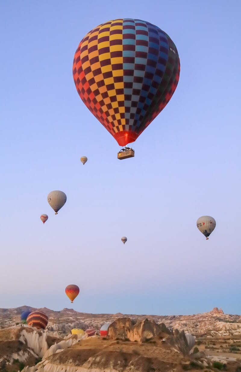 Hot air balloon above fairy chimneys in Cappadocia Turkey