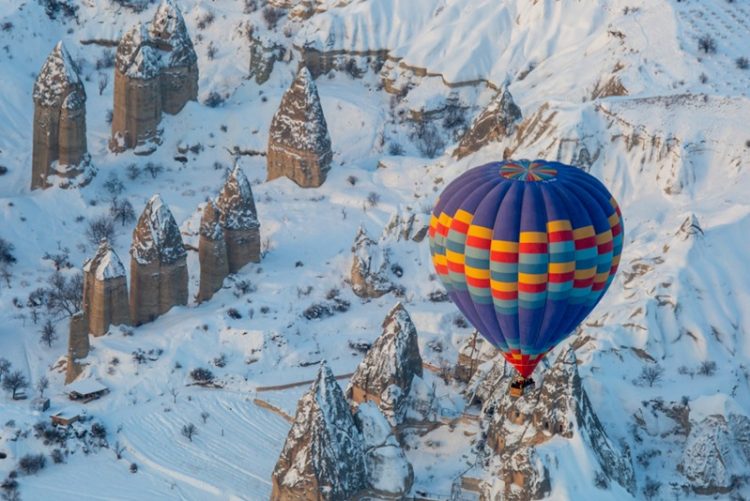 Hot air balloon in winter snow in Cappadocia Turkey