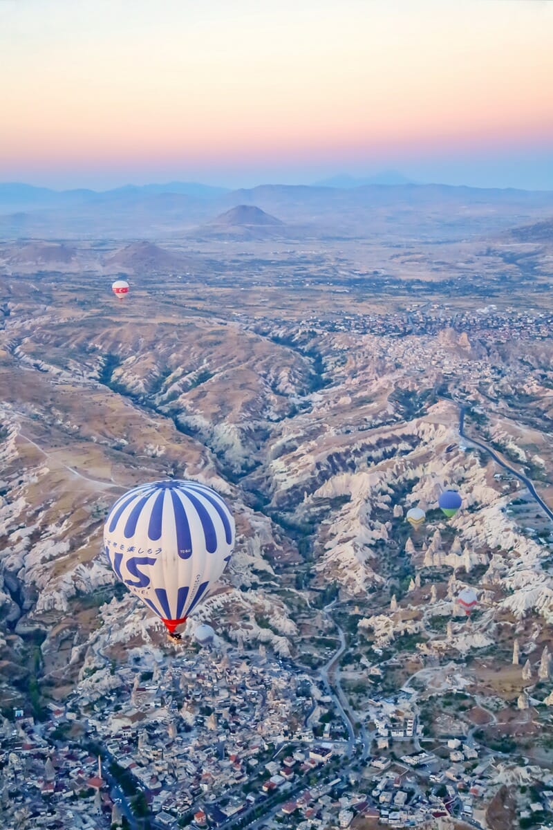 Hot air balloons above Goreme town in Cappadocia Turkey