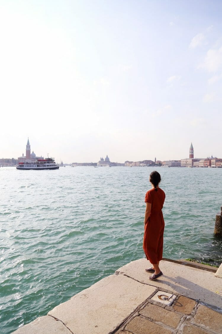 Woman standing at Castello waterfront in Venice Italy
