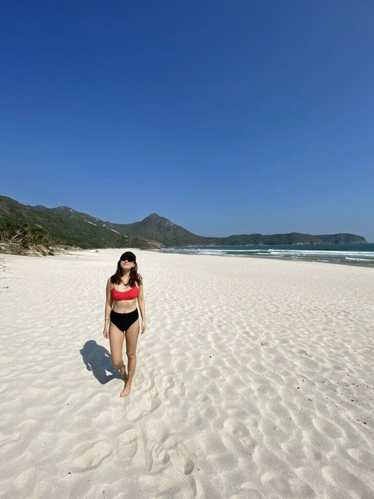 Woman standing on Tai Wan Beach in Tai Long Wan Hong Kong