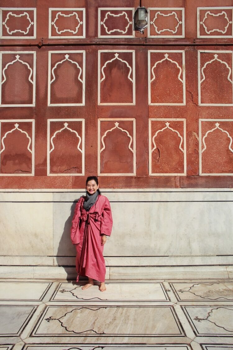Woman standing in front of patterned wall at Jama Masjid in Delhi India