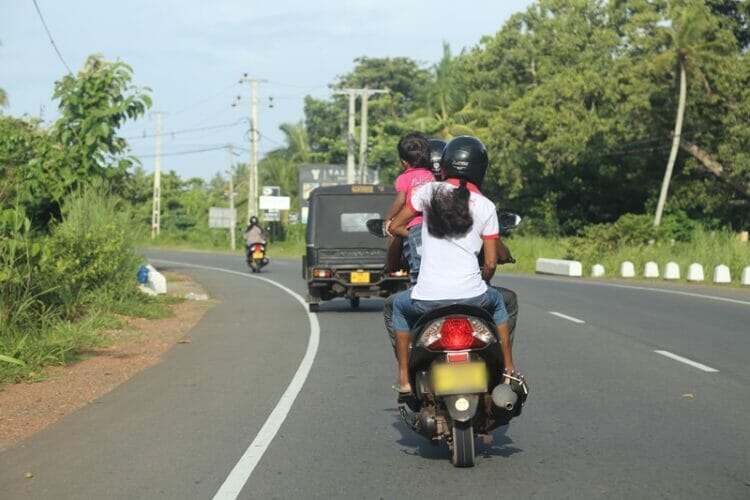 Family driving scooter in Sri Lanka
