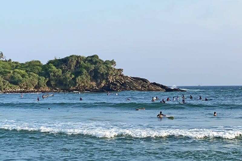 Surfers at Hiriketiya beach in south Sri Lanka