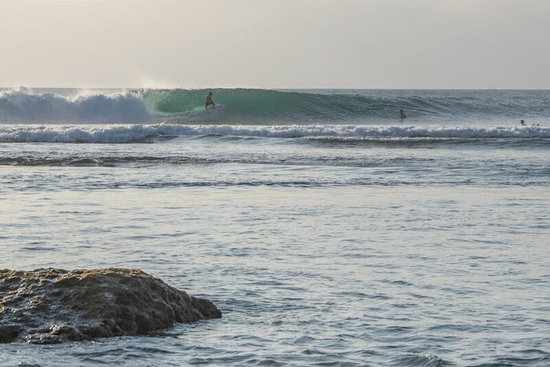 Surfer at Uluwatu Beach in Bali Indonesia