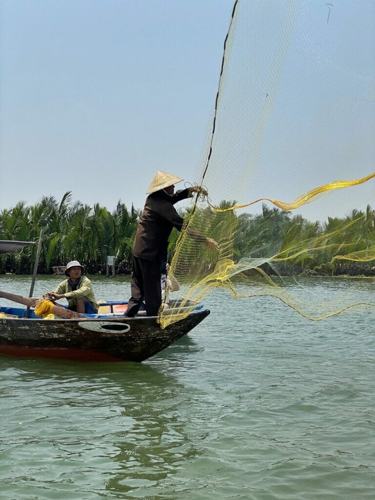 Fisherman at Bay Mau Coconut Forest in Hoi An Vietnam