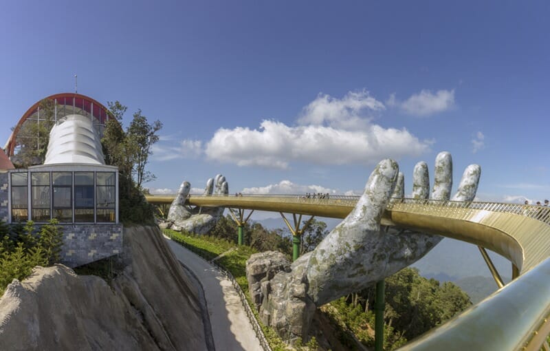 Da Nang, Vietnam - October 31, 2018: Golden Bridge known as “Hands of God”, a pedestrian footpath lifted by two giant hands, open in July 2018 and a landmark at the famous tourist destination of Ba Na Hills in Da Nang, Vietnam.