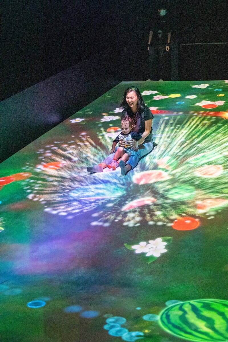 Sliding Through the Fruit Field installation at teamLab in Hong Kong