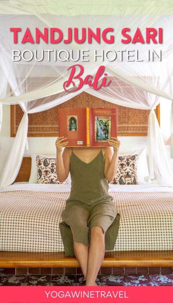 Woman sitting on hotel bed holding book in front of face