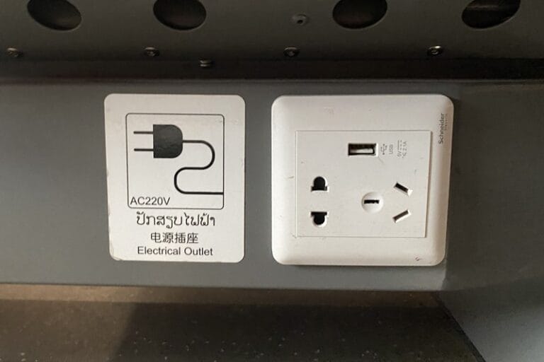 Plug outlets under seat of second class carriage of Laos high speed railway