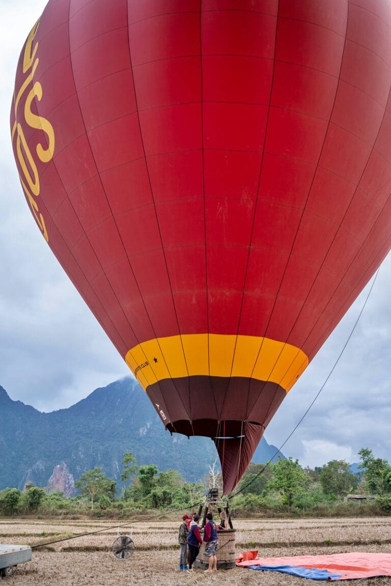 Climbing into a hot air balloon in Laos