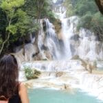 Woman standing in front of Kuang Si waterfall in Laos
