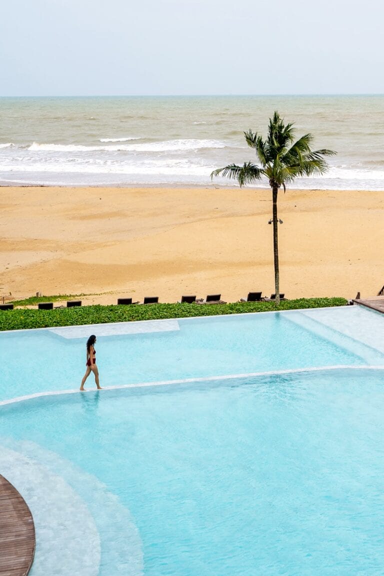 Woman walking along main pool at Devasom Khao Lak in Thailand