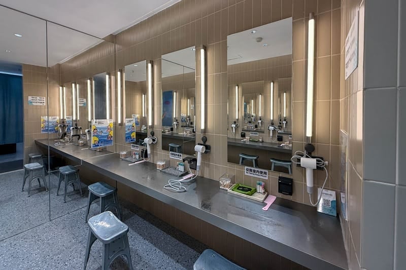 Hair dryers and amenities at public bathroom at Riyue Bay Surf Resort in China