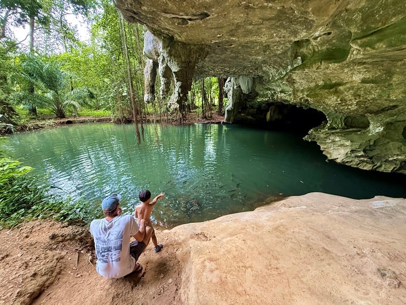 Feeding the fish at Sa Kaeo Blue Lagoon in Krabi Thailand