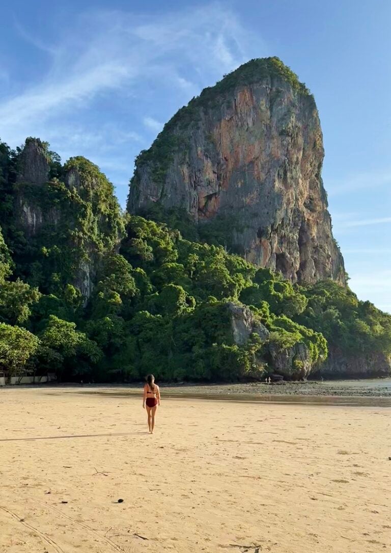 Woman walking on Railay West Beach in Krabi Thailand