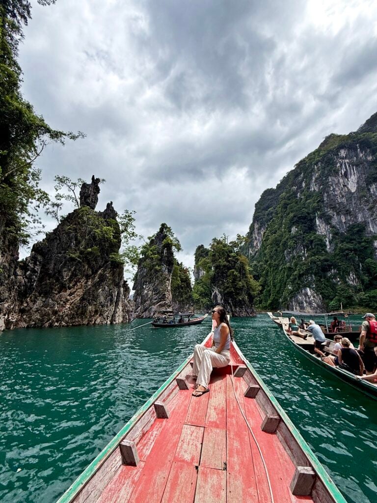 Woman on a longtail boat on Cheow Larn Lake in Khao Sok National Park in Thailand